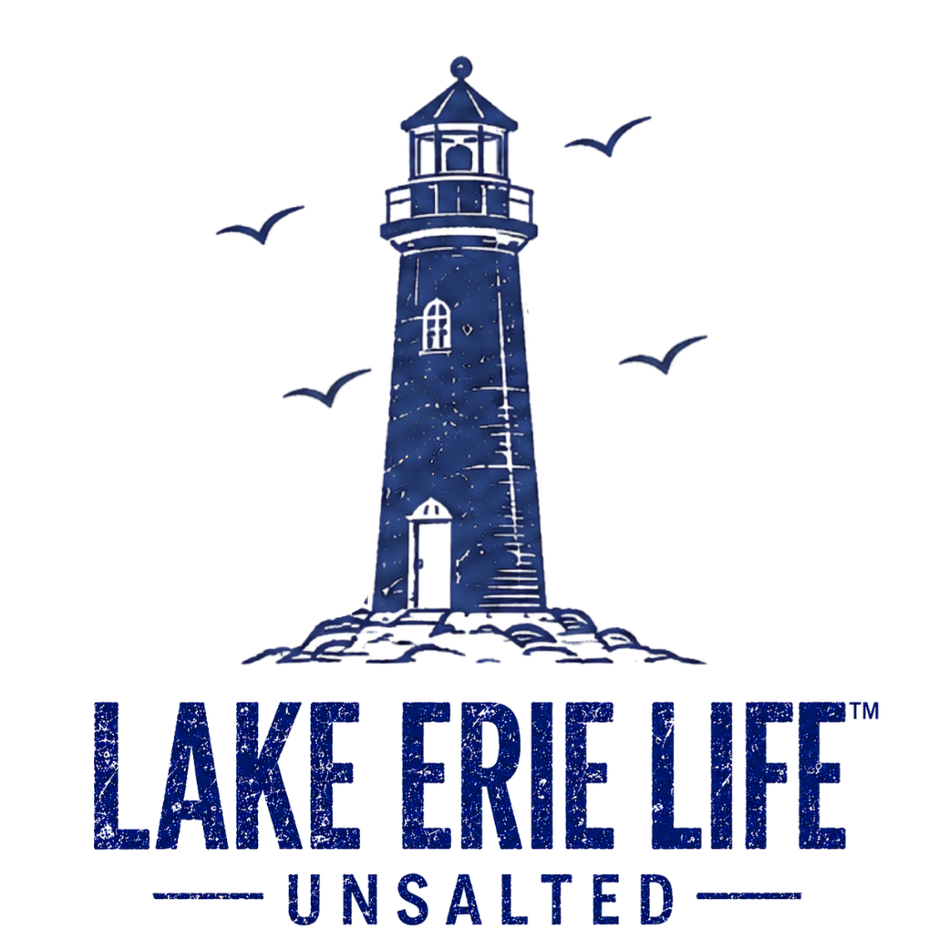 A dark blue graphic logo featuring a lighthouse illustration with seagulls and the text 'LAKE ERIE LIFE UNSALTED' on a plain white background.