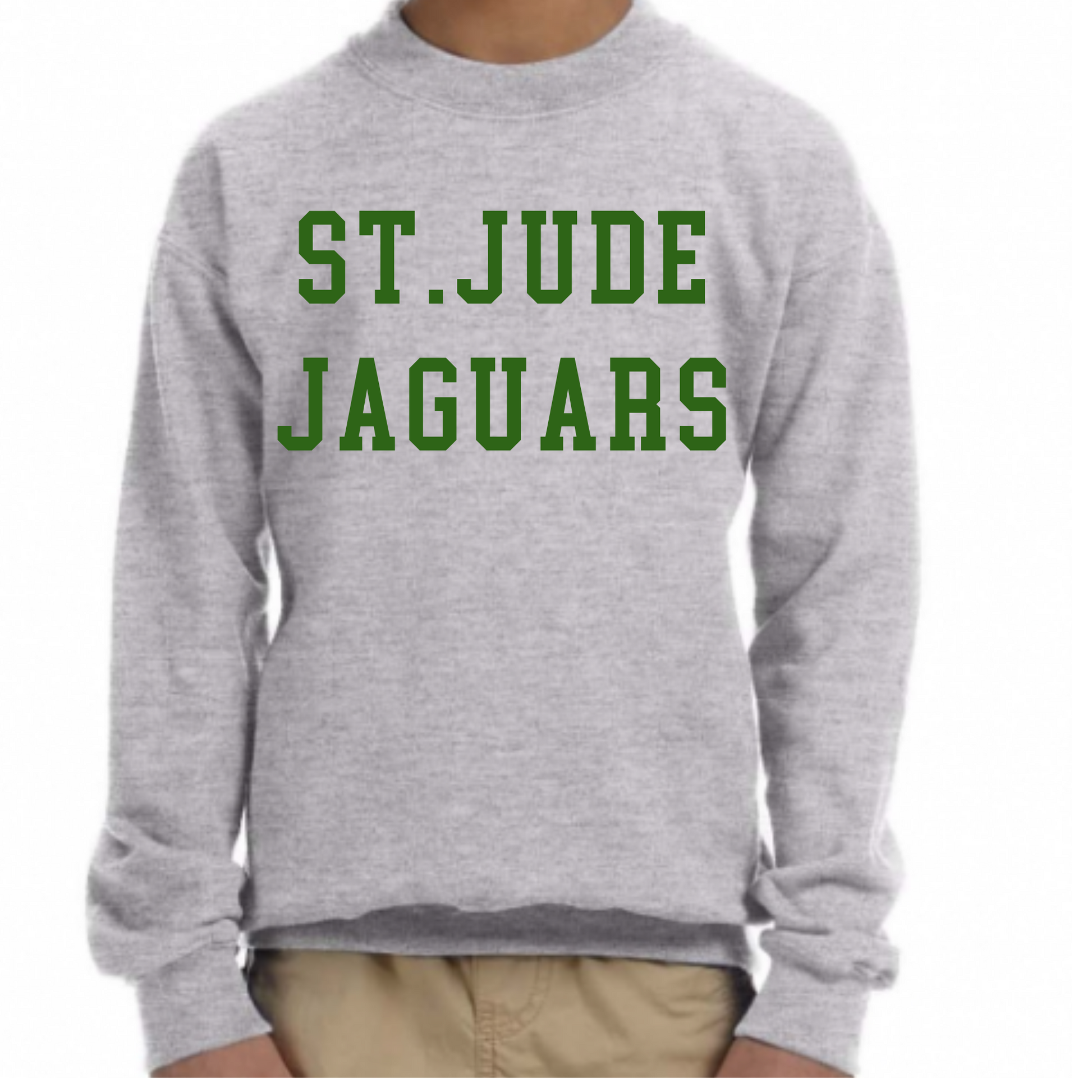A person wearing a light heather gray crewneck sweatshirt with 'ST.JUDE JAGUARS' printed in green block letters across the chest, paired with khaki pants, against a plain white background.