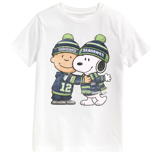 White t-shirt with Charlie Brown and Snoopy wearing Seattle Seahawks-themed clothing on a white background